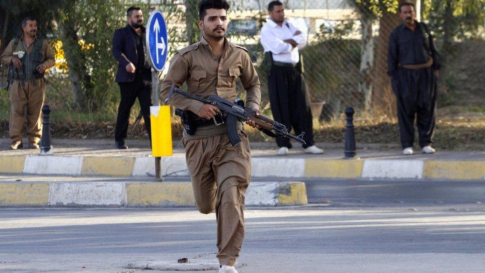 A member of peshmerga forces runs at a site of an attack by Islamic State militants in Kirkuk, Iraq, October 21, 2016.