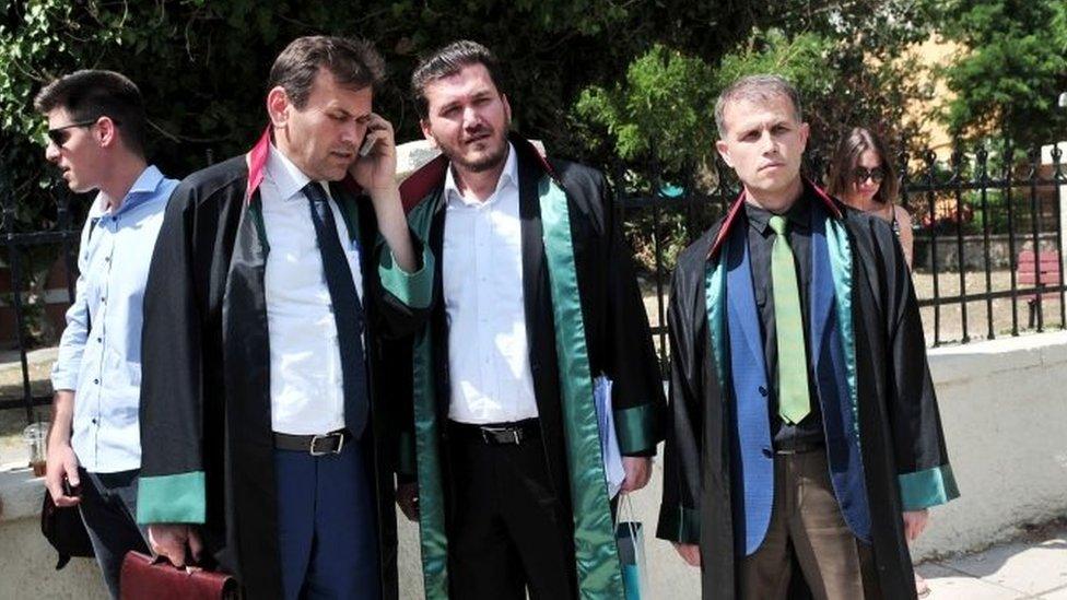 Turkish lawyers stand outside the courthouse after a Greek court sentenced eight Turkish military officers who fled last week's failed coup to suspended two-month prison terms in Alexandroupoli, near the Greek-Turkish border (21 July 2016)