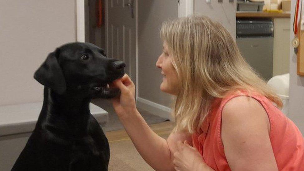 Denise Mariner-Chappell playing with her Labrador Ted