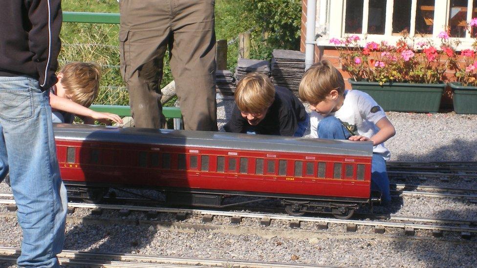 The Waddington brothers looking at a miniature railway carraigeway