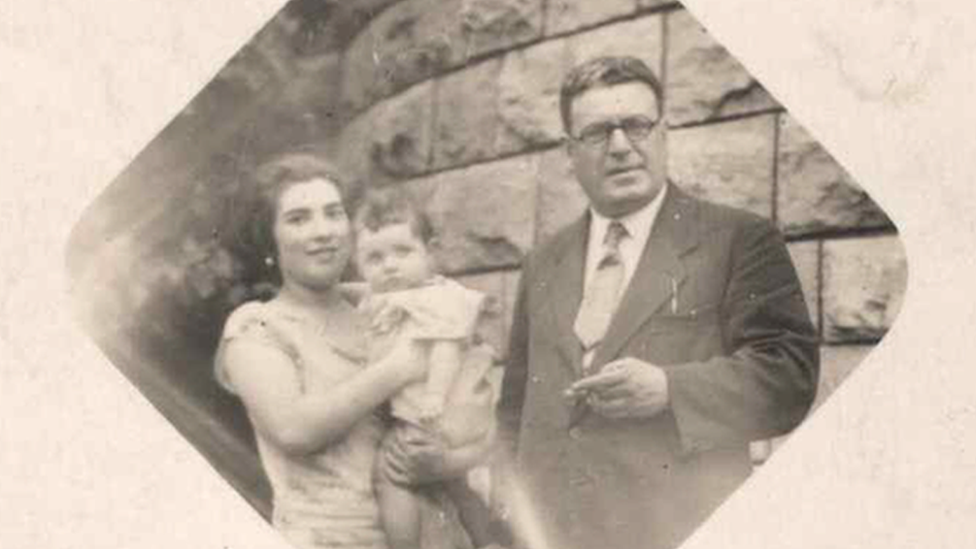 Gabriele Keenaghan as a baby in the arms of her mother who is standing next to her father