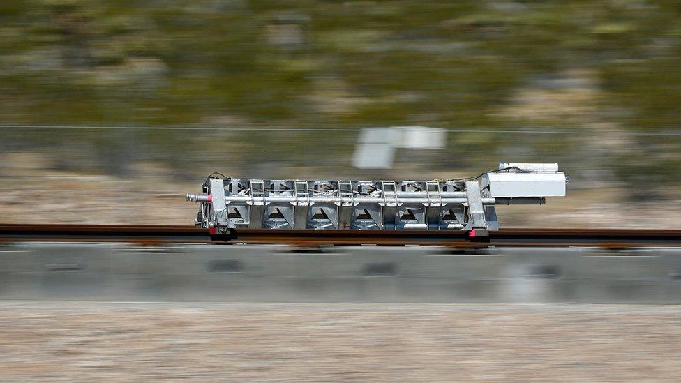 A sled speeds down a track during a test of a Hyperloop One propulsion system, Wednesday,