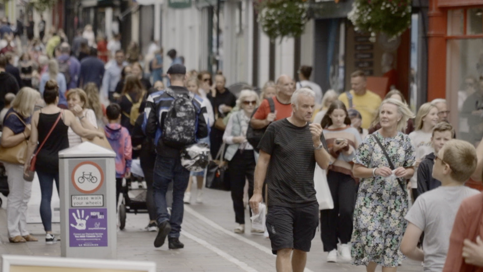 People walking through a street in St Helier, Jersey