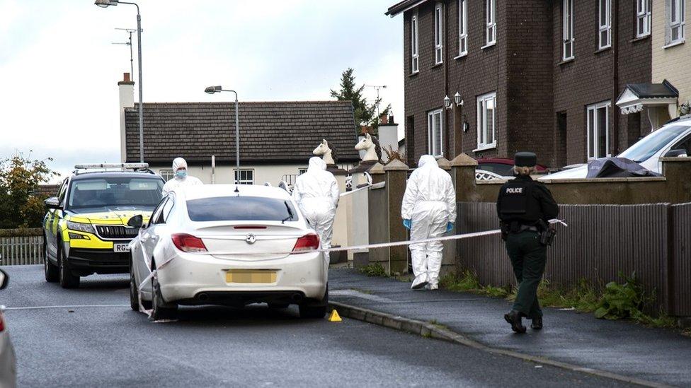 Police outside a house in the Slievecoole Park area