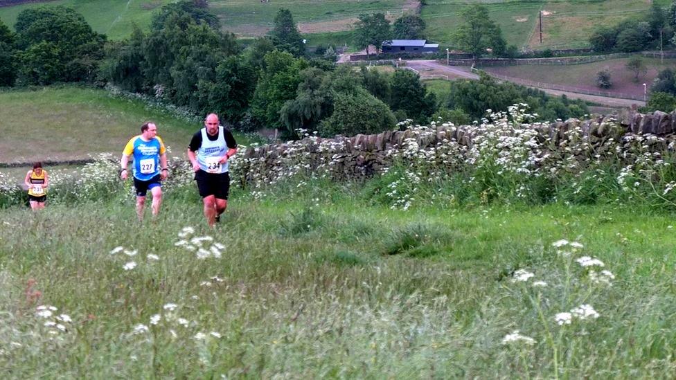 Runners tackling a hill