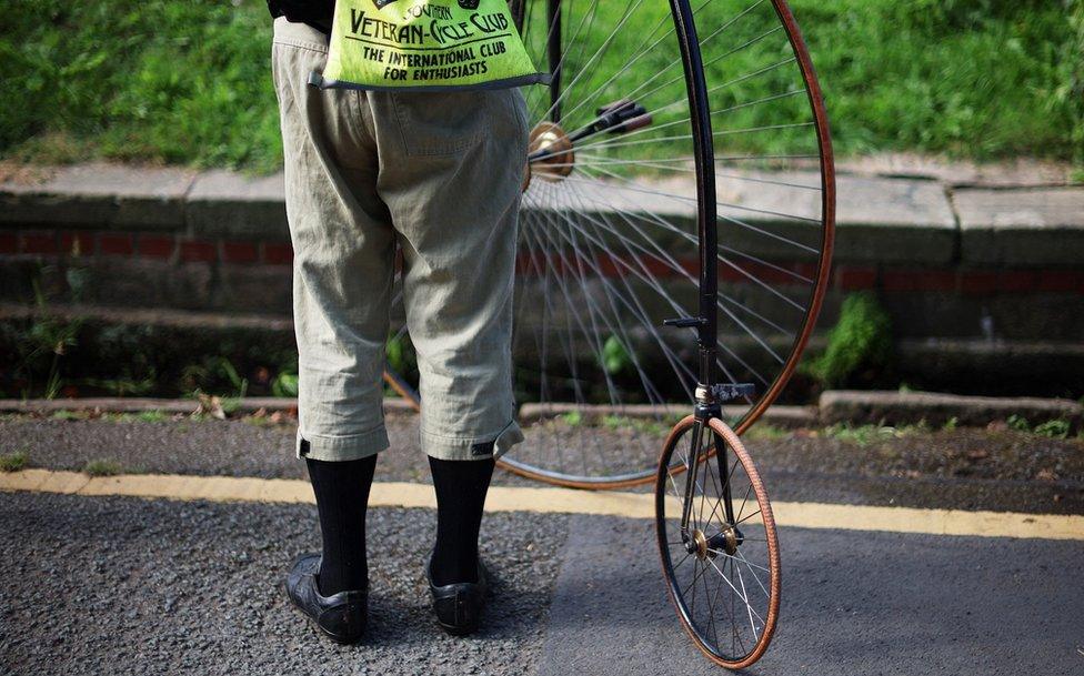 close up on the big and little wheels of the penny farthing