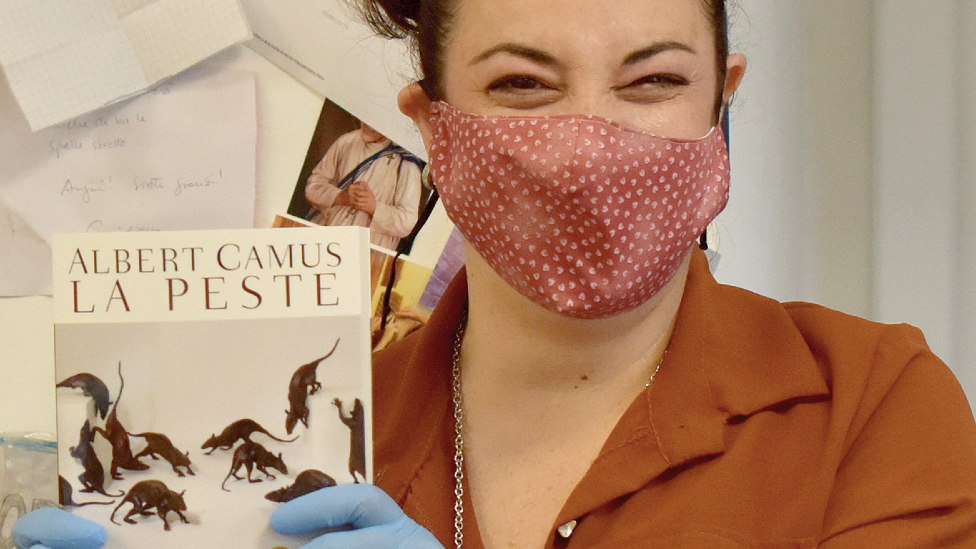 A bookseller with a copy of The Plague (La Peste) in Italy