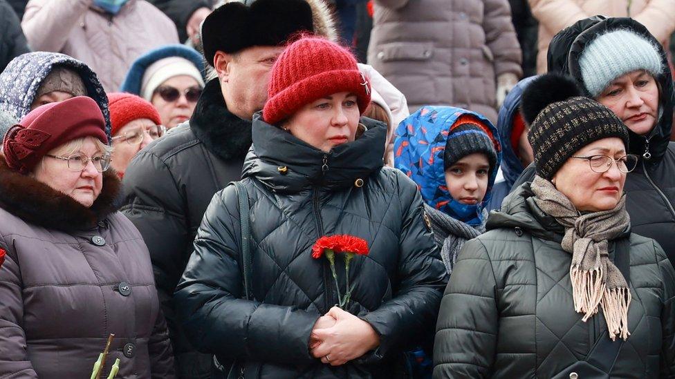 Women hold flowers