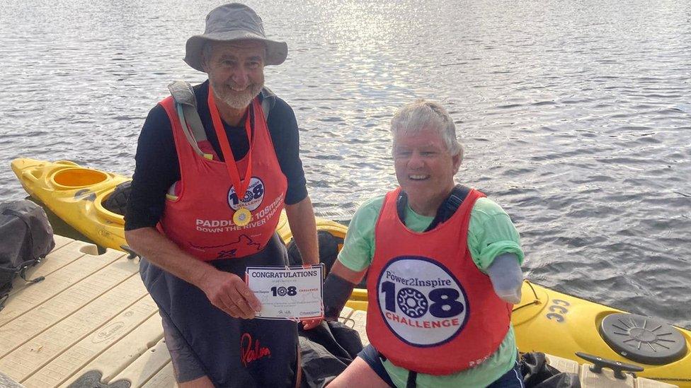 John with another kayaker on the river