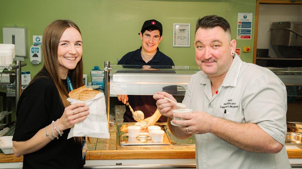 Pictured is Alex Mendez, Catering Assistant; serving Olivia Evans, Improvement Lead; and Karl Mcguire, Healthcare Assistant; free toast and porridge at breakfast.