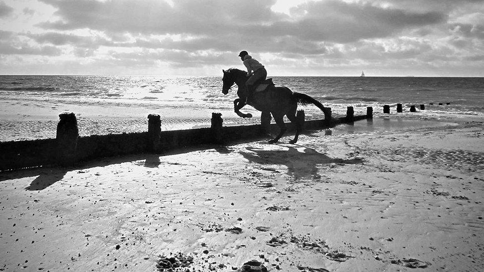 Riding a horse on the beach