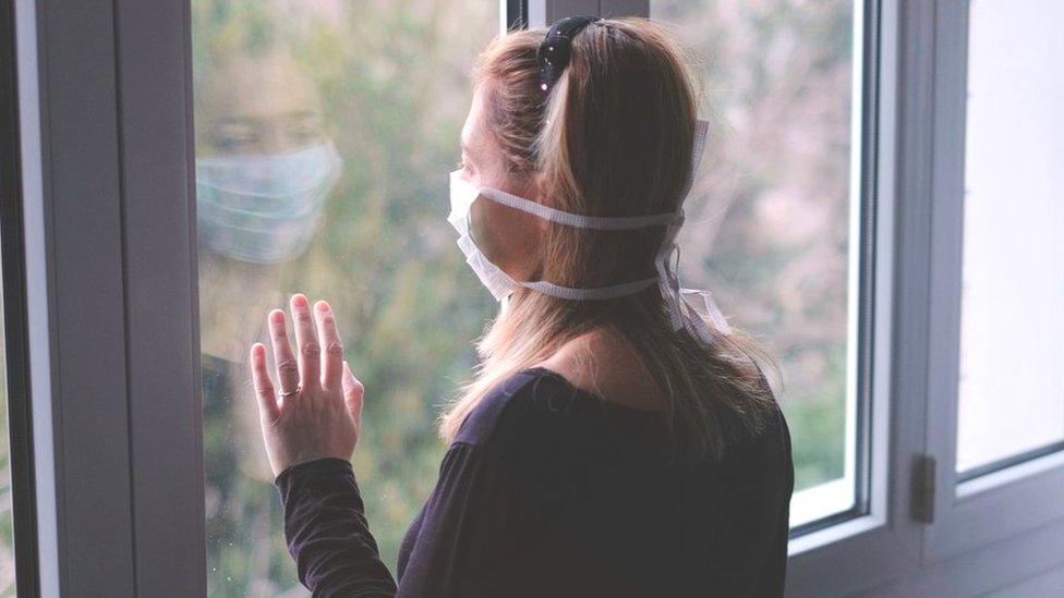 woman looking out of window