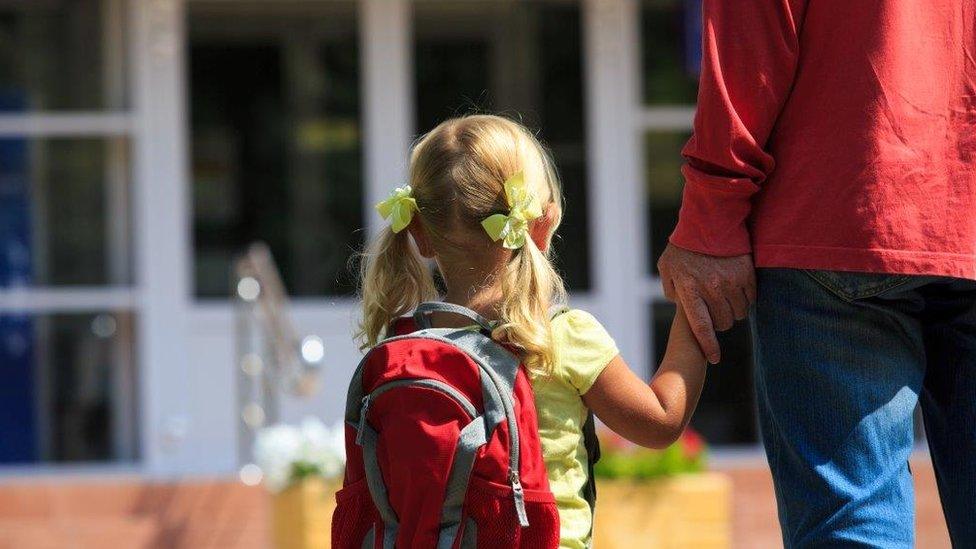 Child holding adults hand