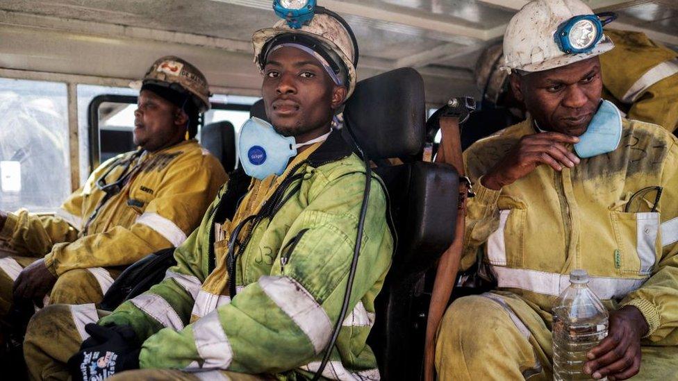 Miners are seen aboard the transport leading them to the start of their 12 hours shift in the Section A of the Khutala Colliery mine in Kendal, on September 29, 2022