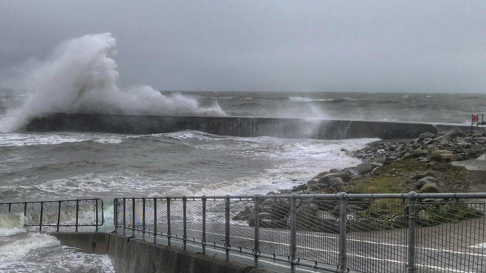 Waves crash on to the front at Criccieth in Gwynedd