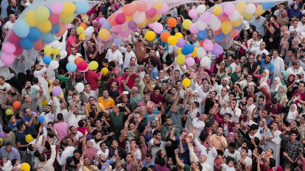 Egyptians release balloons at the end of prayers in Cairo.