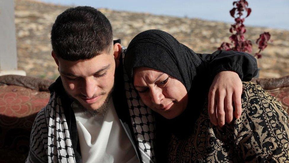 Released Palestinian prisoner Qusai Taqatqa hugs his mother near his house