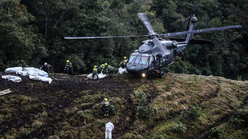 Rescue teams recover the bodies of victims of the LAMIA airlines charter that crashed in the mountains of Cerro Gordo, municipality of La Union, Colombia, on November 29, 2016