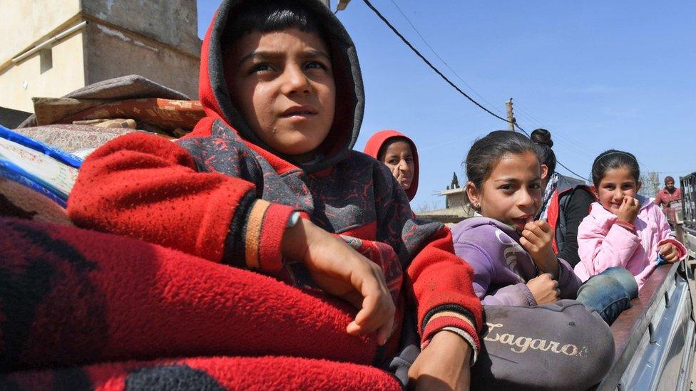 Civilians displaced from Afrin arrive in a government-controlled village in Aleppo province (18 March 2018)