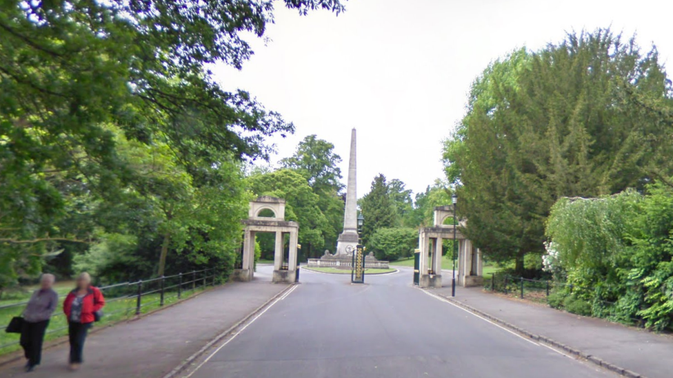 Two people walking by the Royal Victoria Park
