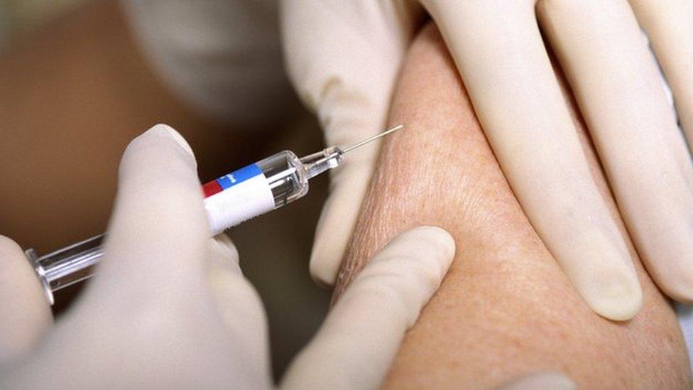 Woman receiving flu vaccination