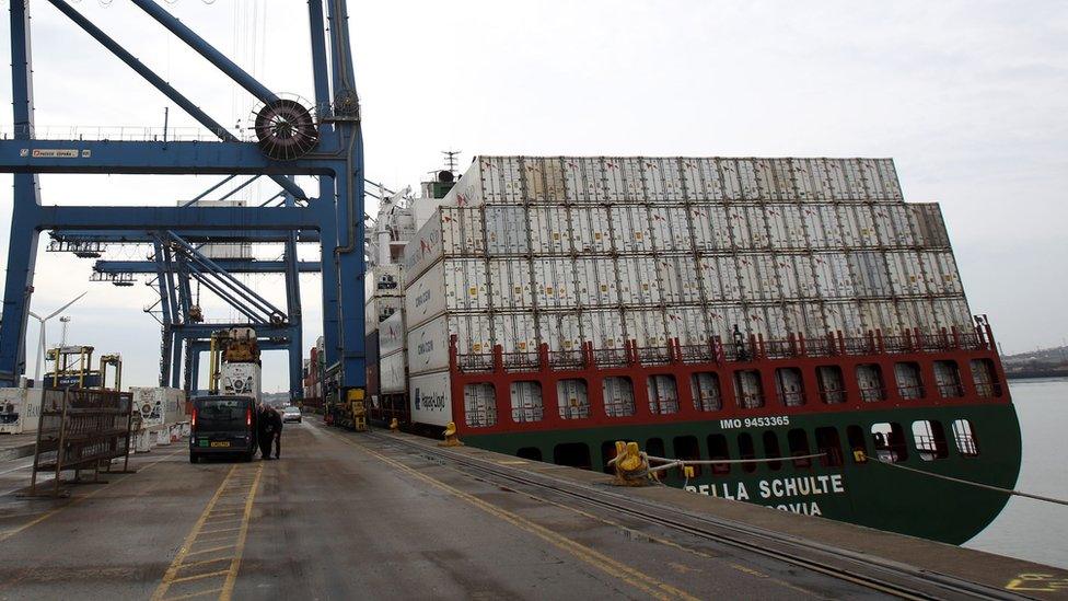 Container ship under crane on dockside