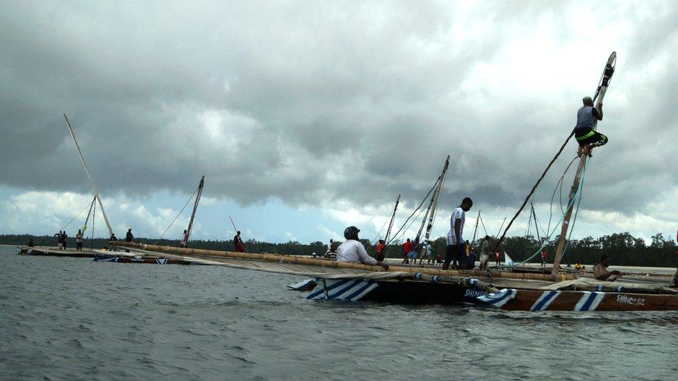 Wrapping up the festival is an ngalawa boat race. Such boats are a typical Swahili design- here, a man climbs the mast to unfurl the sail which, if all goes according to plan, will send his crew gliding into first place over the finish line.