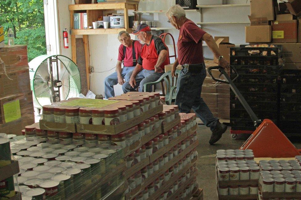 Food pantry, pallets and shelves with groceries