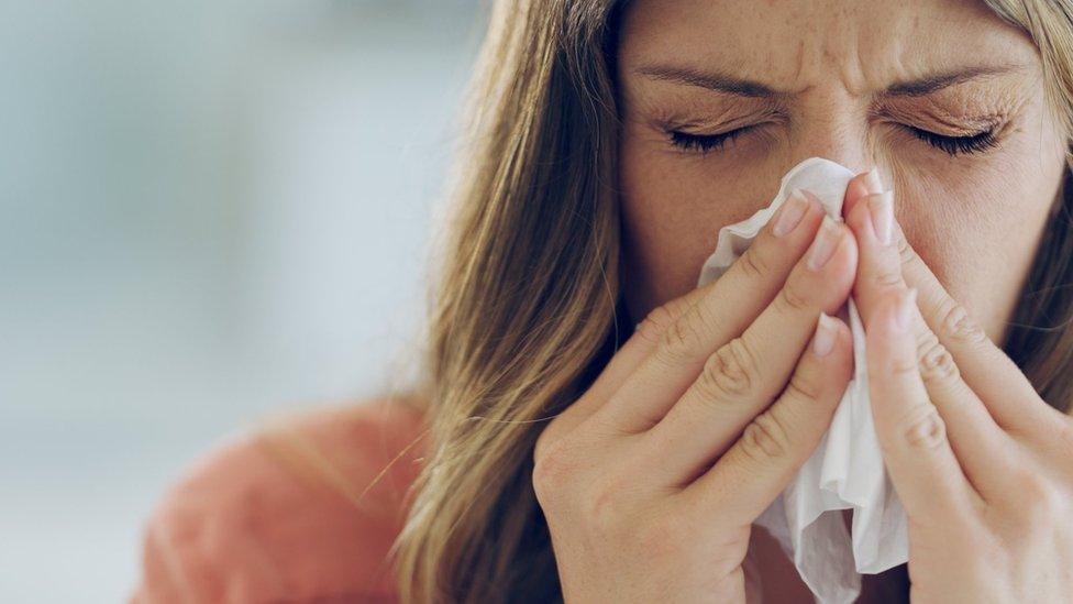 Woman sneezing