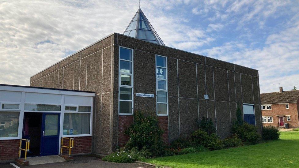 Square church building with glass pyramid roof