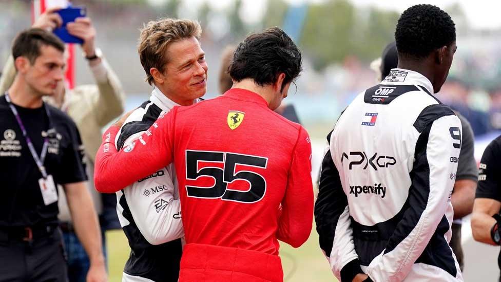 Brad Pitt hugs Ferrari's Carlos Sainz Jr