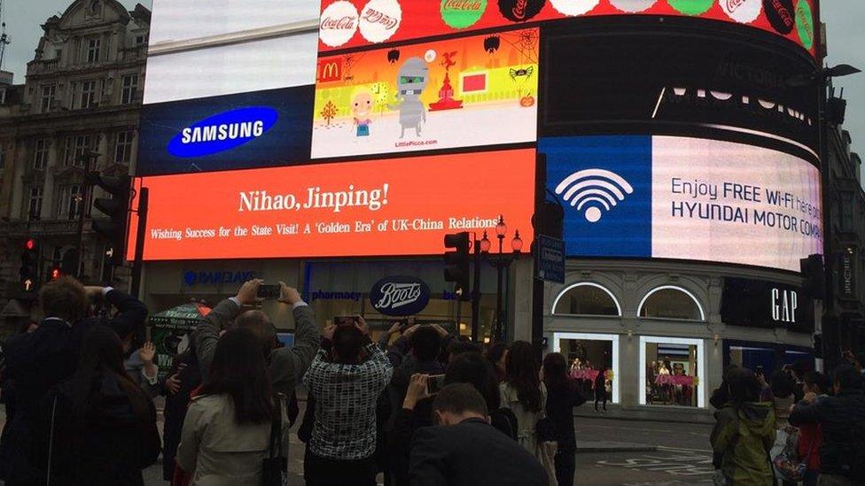 A greeting for China's leader Xi Jinping flashes in London's Piccadilly Square