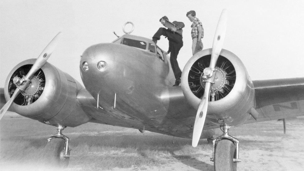 Amelia Earhart and Fred Noonan on their Lockheed plane