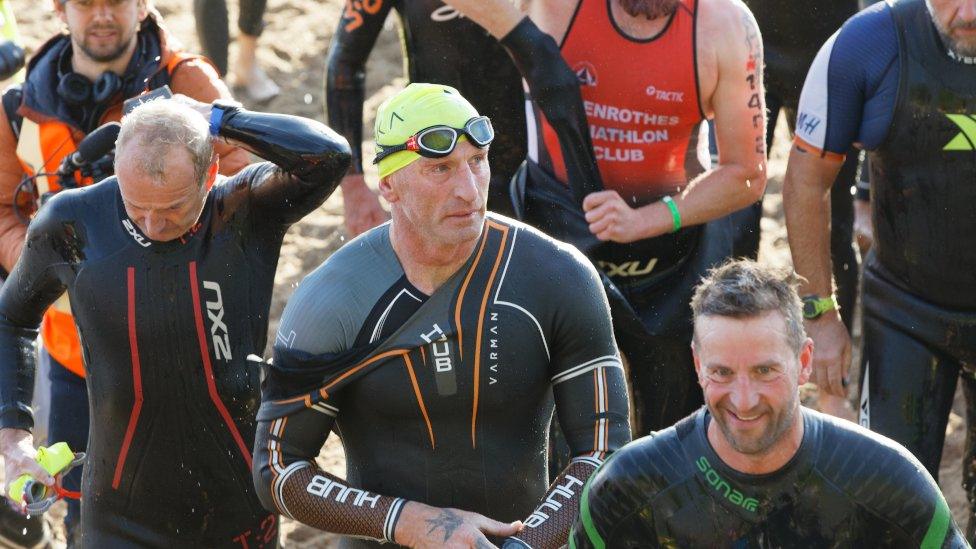 Gareth Thomas emerges from the sea swim in the Ironman triathlon