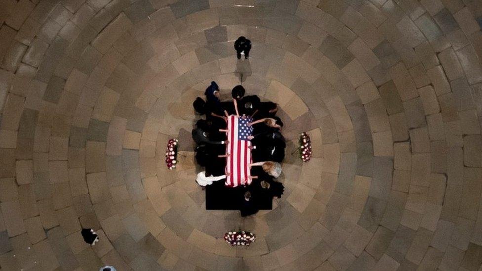 Members of the Faith and Politics Institute pause for prayers to pay their respects to John Lewis