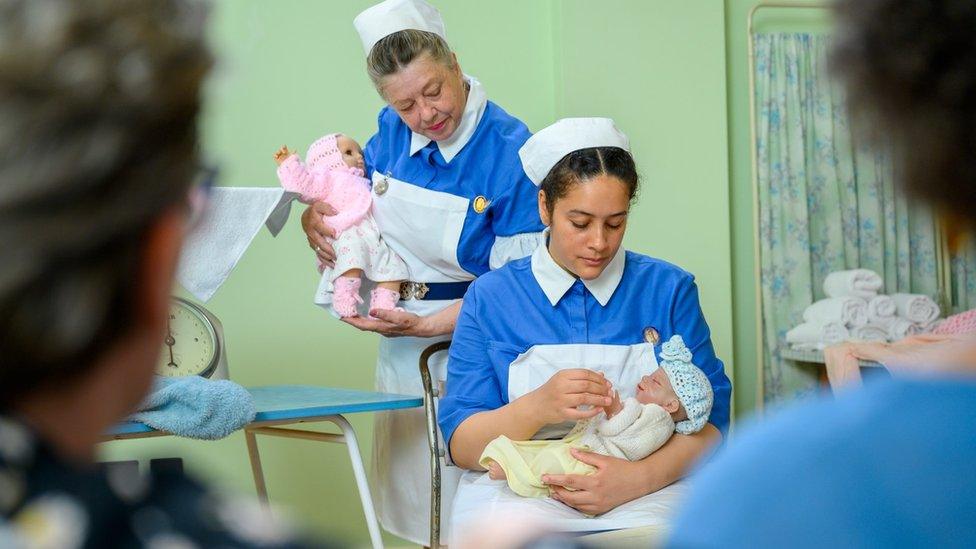 Two midwives with babies