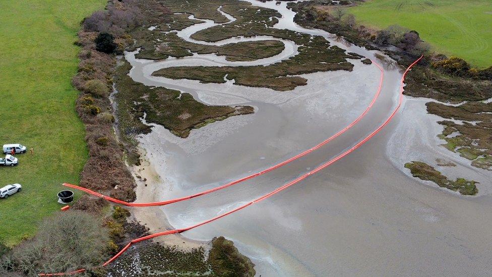 Oil is visible in the water of Poole Harbour, Dorset, following an oil leak from a pipeline at an onshore oil field at the weekend. Picture date: Monday March 27, 2023. PA Photo. Poole Harbour Commissioners (PHC), who regulate activities on the harbour, said a leak occurred at a pipeline operated by gas company Perenco, under Owers Bay on Sunday.