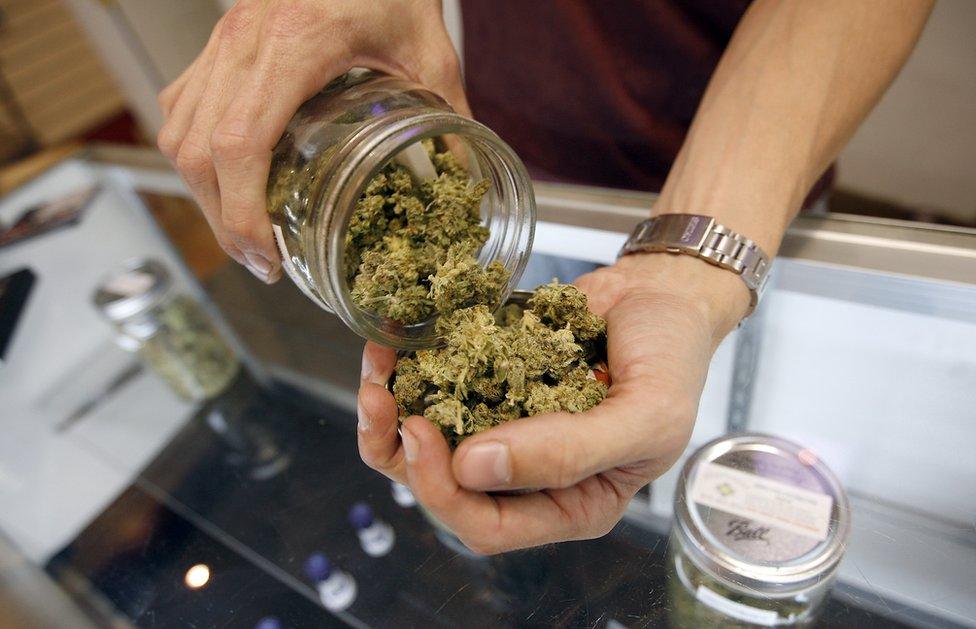 A vendor weighs buds for card-carrying medical marijuana patients in Los Angeles, California