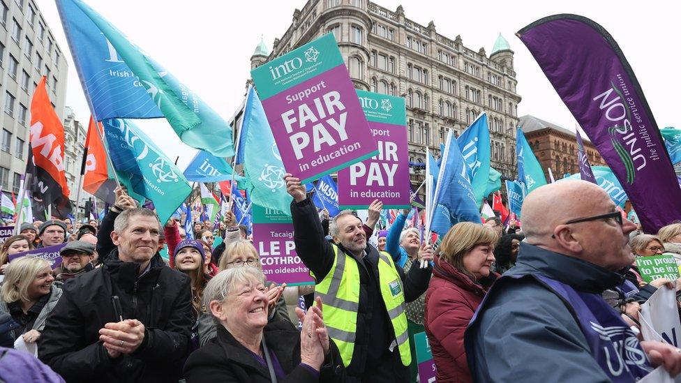 Protesters outside City Hall in Belfast during a trade union rally in support of striking workers