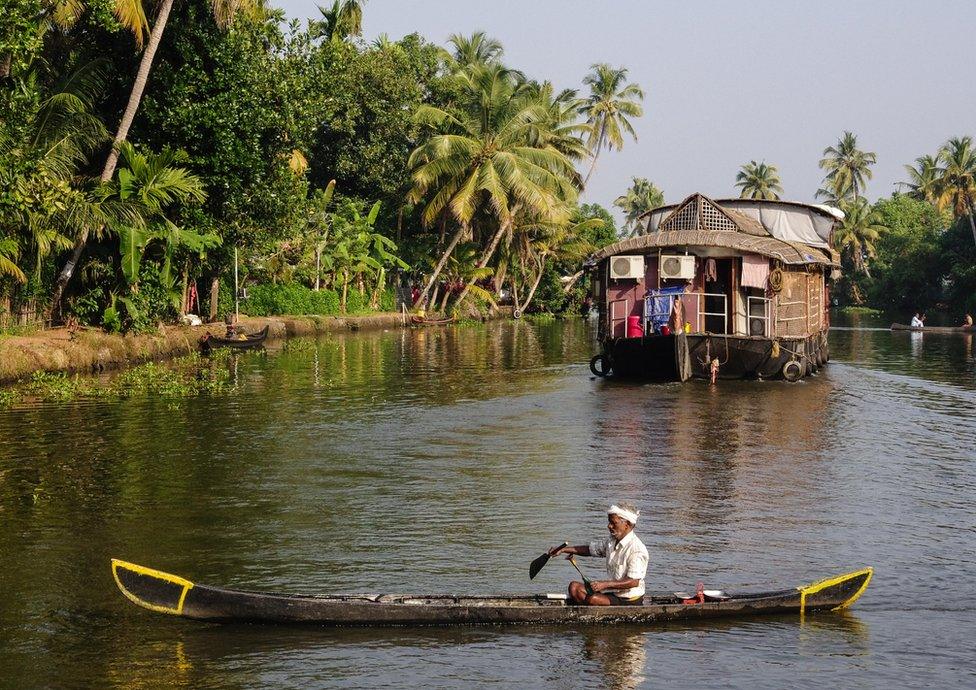 Different types of boats fill a river