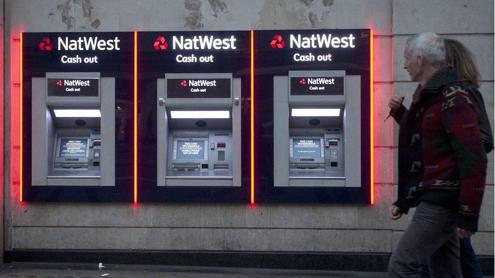 This picture shows people walking past a branch of a NatWest Bank in London