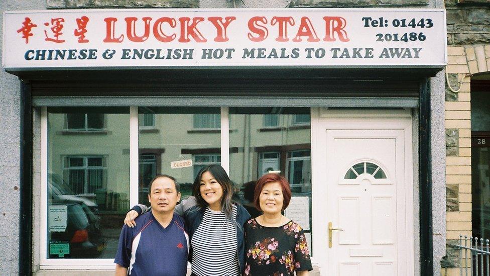 Angela and her parents in 2018 outside the takeaway after her last day of service.