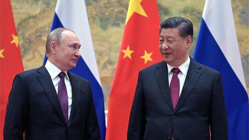 TOPSHOT - Russian President Vladimir Putin (L) and Chinese President Xi Jinping pose for a photograph during their meeting in Beijing, on February 4, 2022.