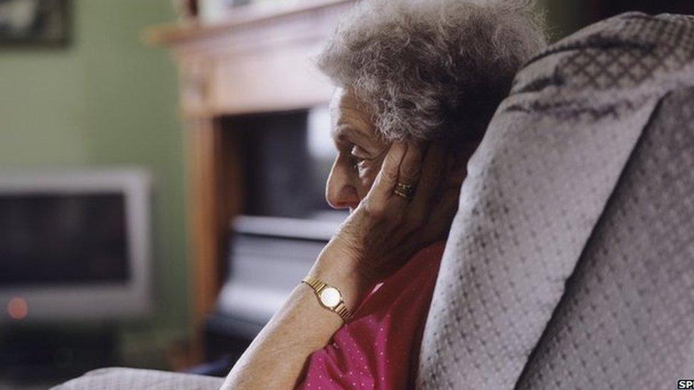 Elderly woman sitting alone