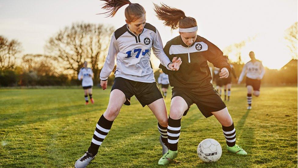 Girls playing football