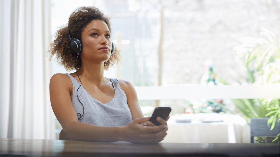 Stock image of a woman listening to music