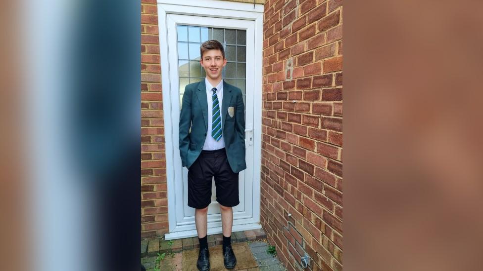 Jamie wearing his shorts and school uniform