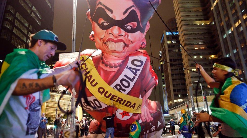 Anti-government demonstrators set up a large inflatable doll in the likeness of Brazil"s President Dilma Rousseff wearing a presidential sash with the words in Portuguese "Goodbye dear" and "Mother of Big Oil" written on it, in Sao Paulo, Brazil, Wednesday, May 11, 2016