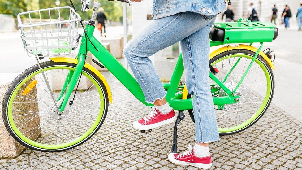 Person getting on an e-bike