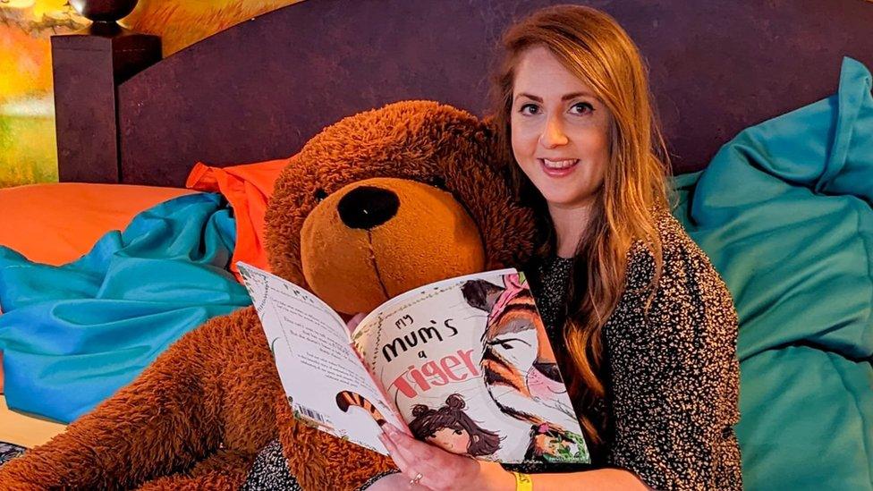 Kate Claxton with her book and a giant teddy